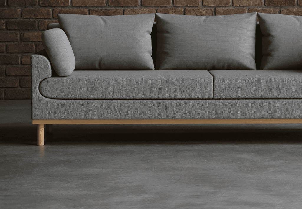 canapé anthracite couleur sombre fait écho au béton ciré et au métal présent dans la structure