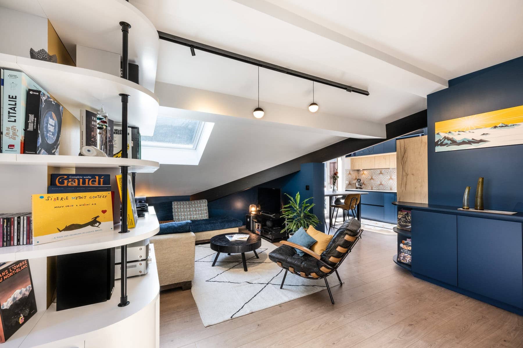 Salon sous combles entre Albertville et Les Arcs avec poutres blanches, mur bleu nuit et déco vintage